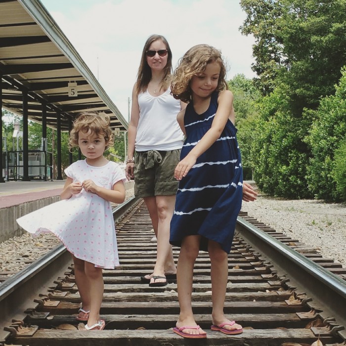 Sarah and her girls on the train tracks in their hometown, Southern Pines, NC